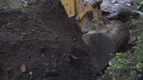 Excavator shovel digs into a ground Stock Footage 94460718