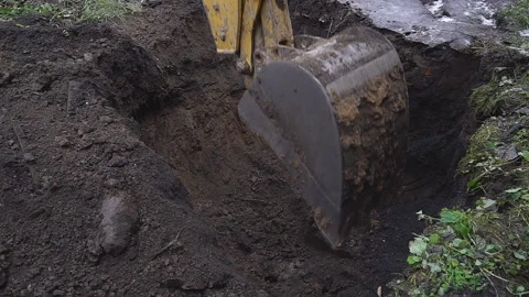 Excavator shovel digs into a ground Stock Footage 94460897