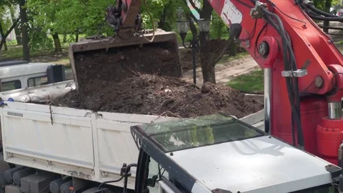 Excavator shovel loading trailer of tipper truck, crane shot. Stock Footage 76656905