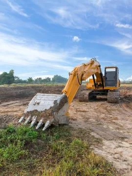 Excavator standing with cloudscape sky 写真素材