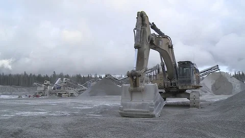 Excavator stands on the background of a stone processing plant Stock Footage 82304998