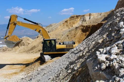 Excavator on the stone mine Stock Photos