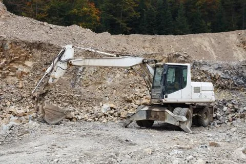 Excavator in stone-pit Stock Photos