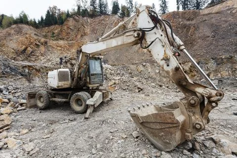 Excavator in stone-pit Stock Photos