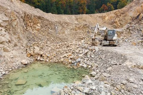 Excavator in stone-pit Stock Photos