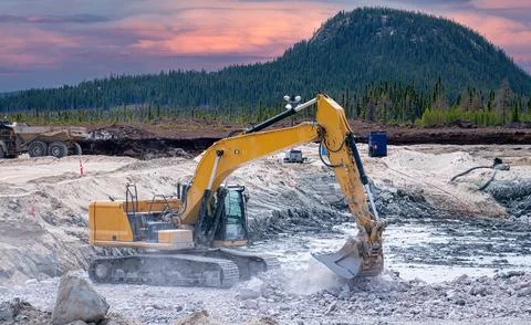 Excavator at sunset Stock Photos