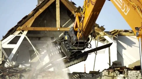 Excavator taking down debris - 4K Video stock 69162376
