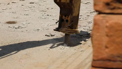 Excavator tearing road surface for construction work at day Stock Footage 313367467