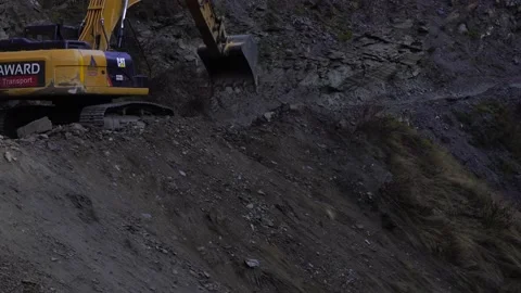 Excavator throws boulders into the river Stock Footage 153070092