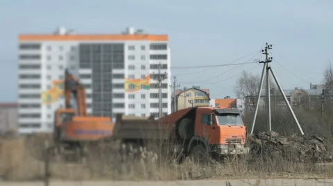 Excavator uploads a clay in a truck using a bucket Stock Footage 63470254
