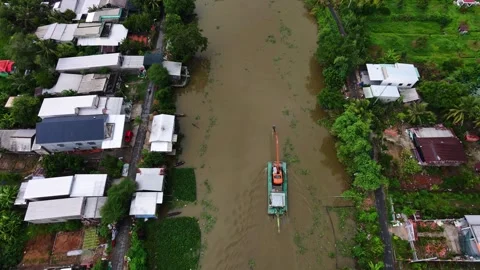 Excavator using its bucket as a paddle to steer and push barge along canal Stock-Footage 341229702