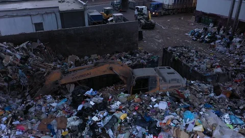 Excavator at the waste processing plant Stockbeeldmateriaal 129639256