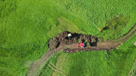 Excavator At Work Digging Soil On Lush Field In Summer Stock Footage 261585517