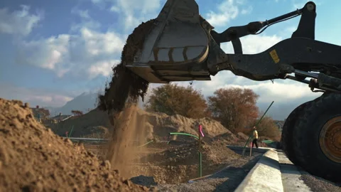 Excavator at work during field construction in bright daylight Stock Footage 310285030
