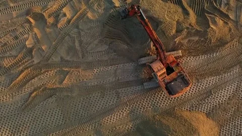 Excavator at work leveling the surface with sand at a construction site top view Stock Footage 204851011