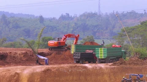 Excavator on Work, Ploughing Soil in the Construction Site Stock Footage 132319135