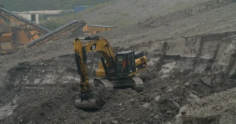 Excavator at work in a quarry, transporting soil, long shot, Germany 4K Stock Footage 95742395