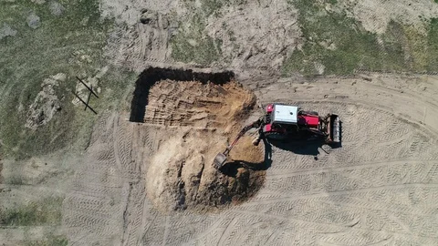 Excavator at work trenching at a construction site. Arial view. Stock Footage 128947464