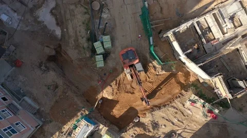 Excavator is working and digging on the building from the top on a sunny day. Stock Footage 231794694