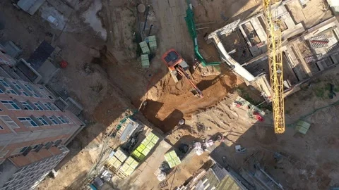 Excavator is working and digging on the building from the top on a sunny day. Stock Footage 231794733