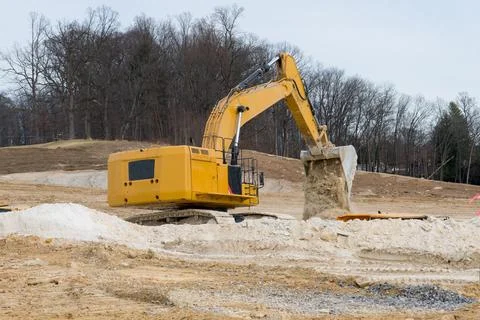 Excavator is working and digging at construction site Stock Photos