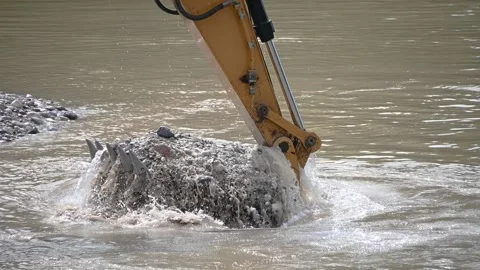 Excavator working and digging from river sand and pebbles Stock Footage 136125151