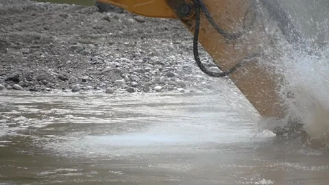 Excavator working and digging from river sand and pebbles Stock Footage 136125242