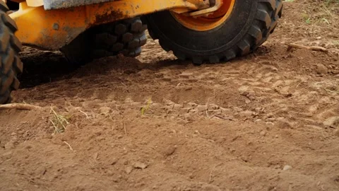 Excavator working. Backhoe operating in a Land. Wheels close up Stock Footage 153814398