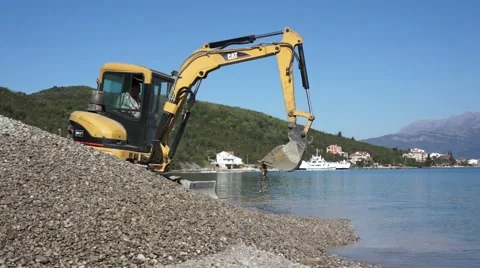 Excavator working on the beach Stock Footage 49332483