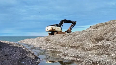 Excavator Working On Beach Pebble Mound Stock Footage 341610145