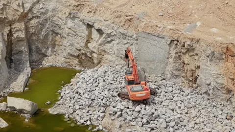 Excavator Working at Bottom of Deep Stone Quarry Video stock 341635487