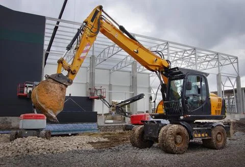Excavator working with a bucket on the construction of structures Stock Photos
