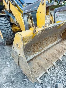 Excavator working on a construction site during the day in an urban area Stock Photos