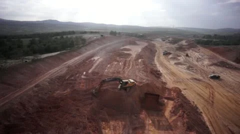 Excavator working on a construction site- long shot aerial shot Stock Footage 22242420