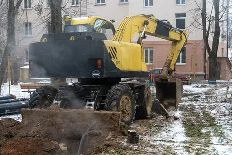 The excavator is working on the construction site to replace the pipeline in  Stock Photos