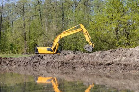 Excavator working in the countryside Stock Photos