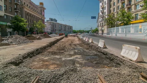 Excavator working on earthmoving at open pit mining in the city street timelapse Stock Footage 190389157