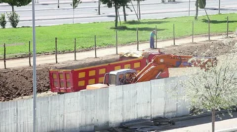 An excavator working with a labourer behind Stock Footage 11402629