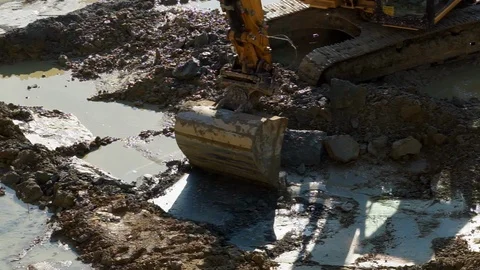 A excavator working moving earth at  a construction site Stock Footage 88702899