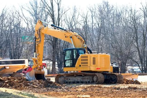 Excavator on a working platform yellow Stock Photos