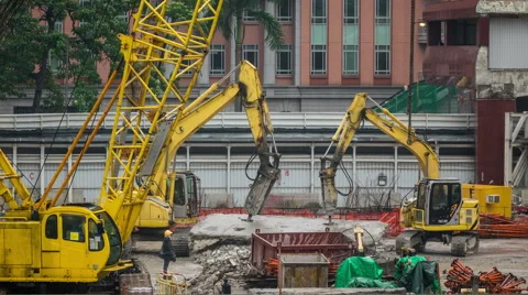 Excavators and cranes on the construction site under construction skyscraper. Video stock 56451941