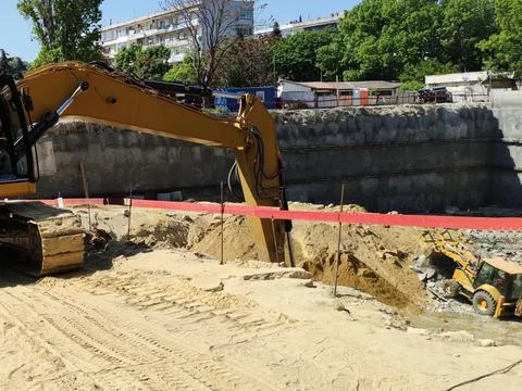 Excavators are digging a foundation pit for a large building Stock Photos