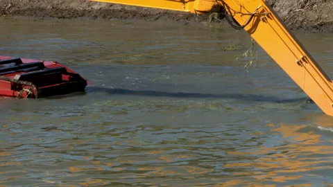 Excavators are working to clear Mud Sludge and Debris from the Bottom of river. Video stock 137067697