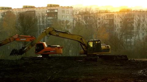 Excavators cleans and deepens the river bed at sunset. Stock Footage 98685748