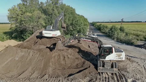 Excavators dig the ground while building a road Stock Footage 191517302
