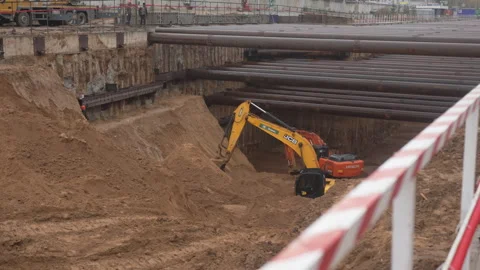 Excavators dig soil preparing pit for pipeline system repair Stock Footage 313828114