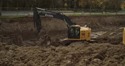 Excavators digging in construction site Stock Footage 117182843