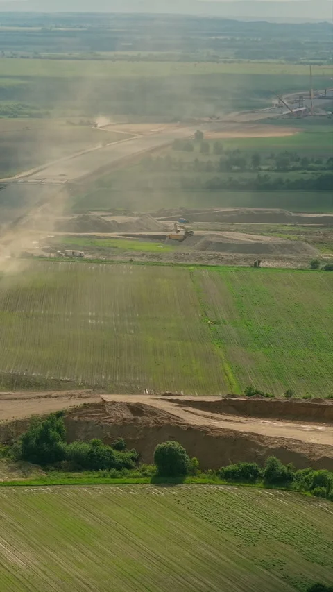 Excavators Digging Earth In Adjacent Areas To Provide Materials For A Massi.. 스톡 동영상 338179967