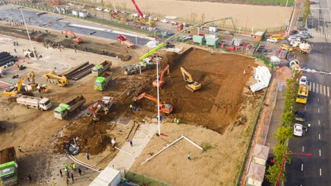 Excavators digging foundations, Wuhan COVID19 hospital construction, drone Stock Footage 130881122