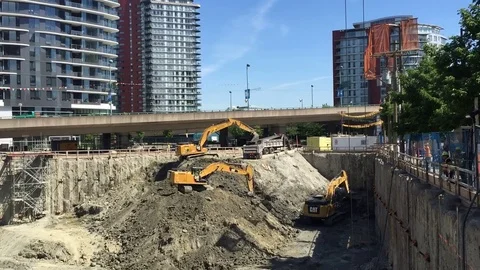 Excavators digging out massive construction site. Video stock 76372001